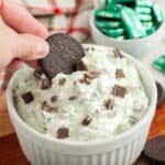 Bowl with Oreo cookie dipping into mint chocolate chip dip.