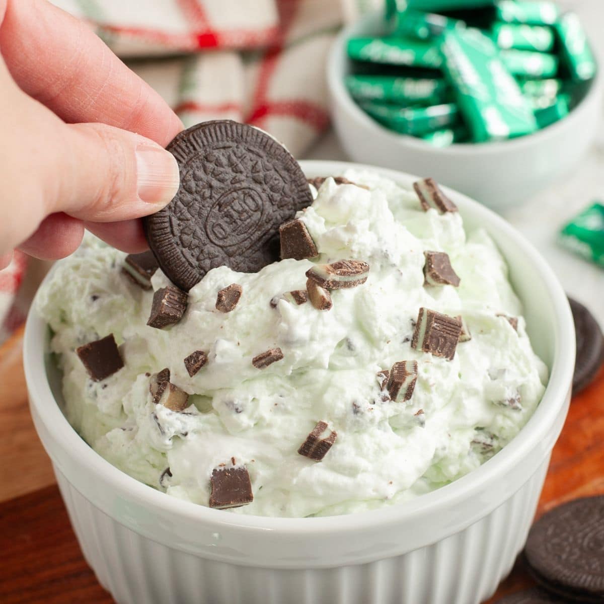 Bowl with Oreo cookie dipping into mint chocolate chip dip.