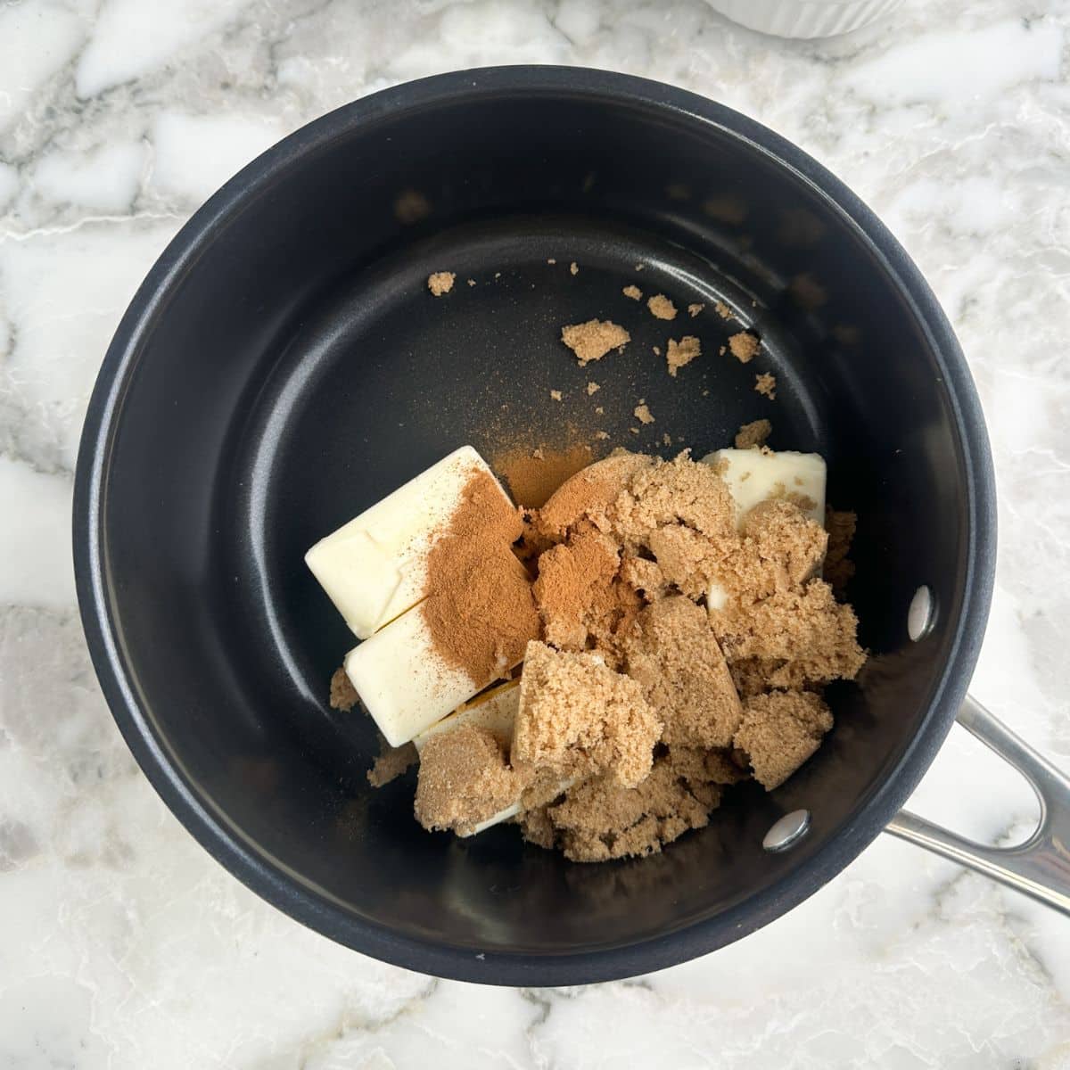Saucepan with butter, brown sugar, and cinnamon.