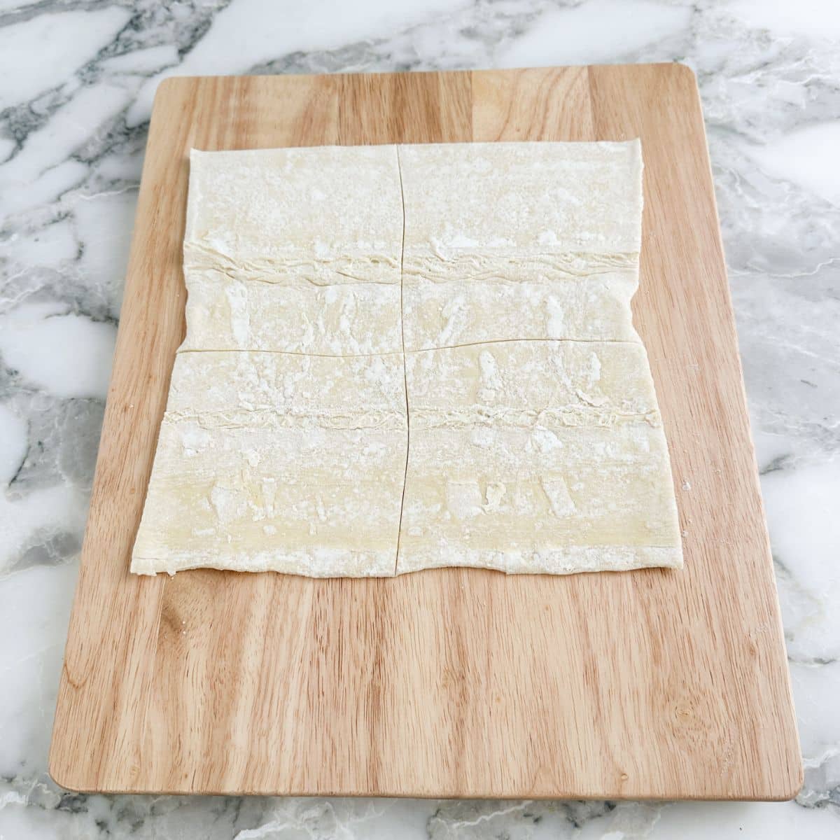 Puff pastry on a cutting board.