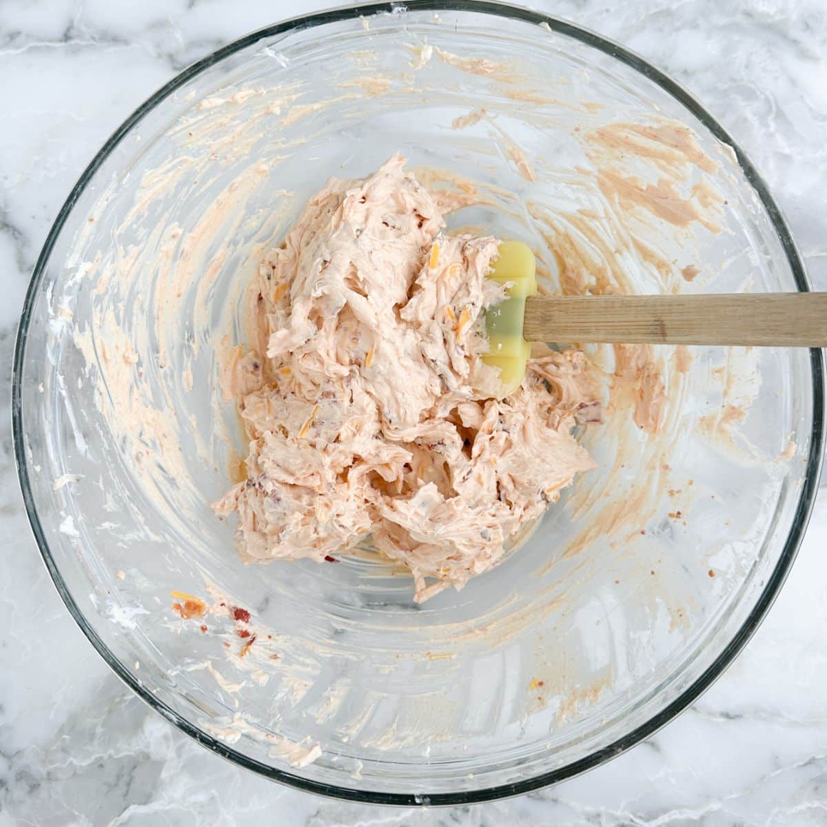 Bowl of cream cheese dip with a spatula.