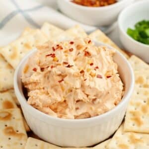 Bowl of fire cracker dip topped with red pepper flakes.