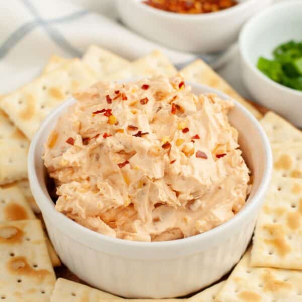 Bowl of fire cracker dip topped with red pepper flakes.