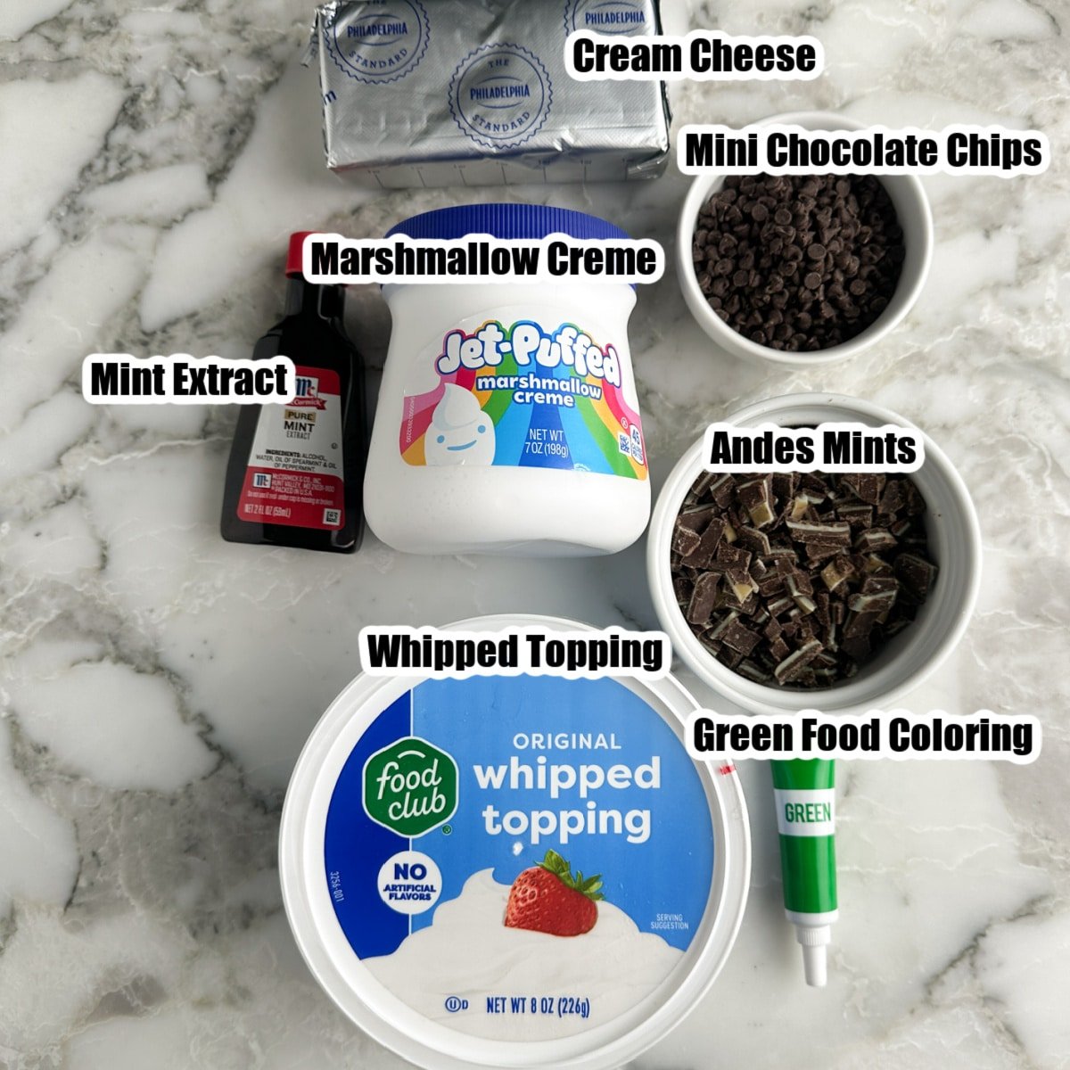 Jar of marshmallow creme, chocolate chips, Andes mint candy, whipped topping, cream cheese, and green food coloring.