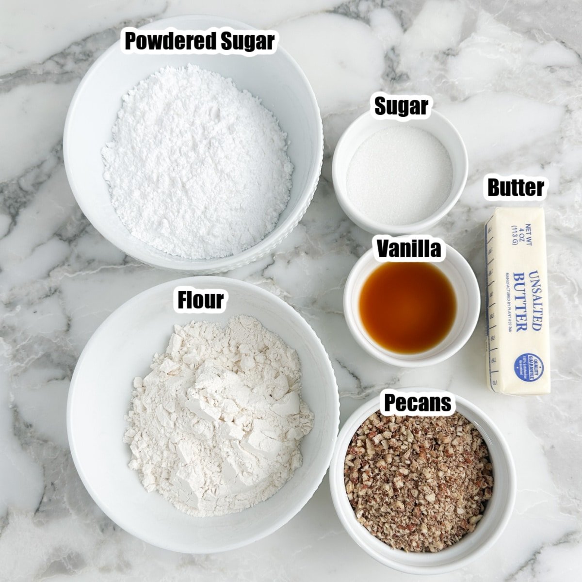 Bowl of powdered sugar, flour, sugar, vanilla, pecans, and butter.