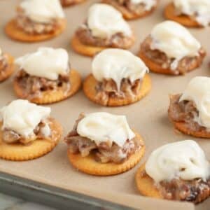 Pan with Ritz crackers topped with pecans and frosting.