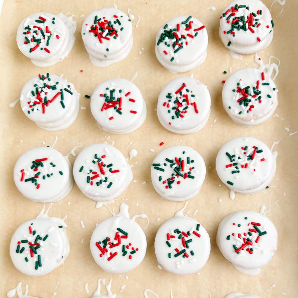 Baking sheet with white chocolate covered Ritz crackers with sprinkles.