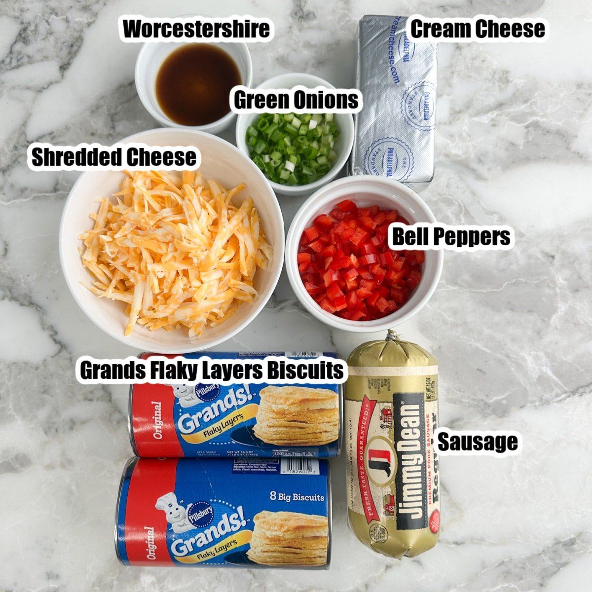Grands Biscuits, bowl of shredded cheese, peppers, onions, sausage, and cream cheese.