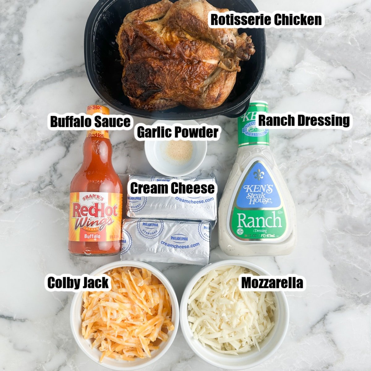 Rotisserie chicken, bottle of buffalo sauce, ranch dressing, cream cheese, and shredded cheese.