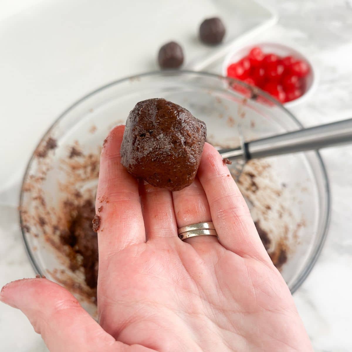 Hand holding a brownie bite bowl. 