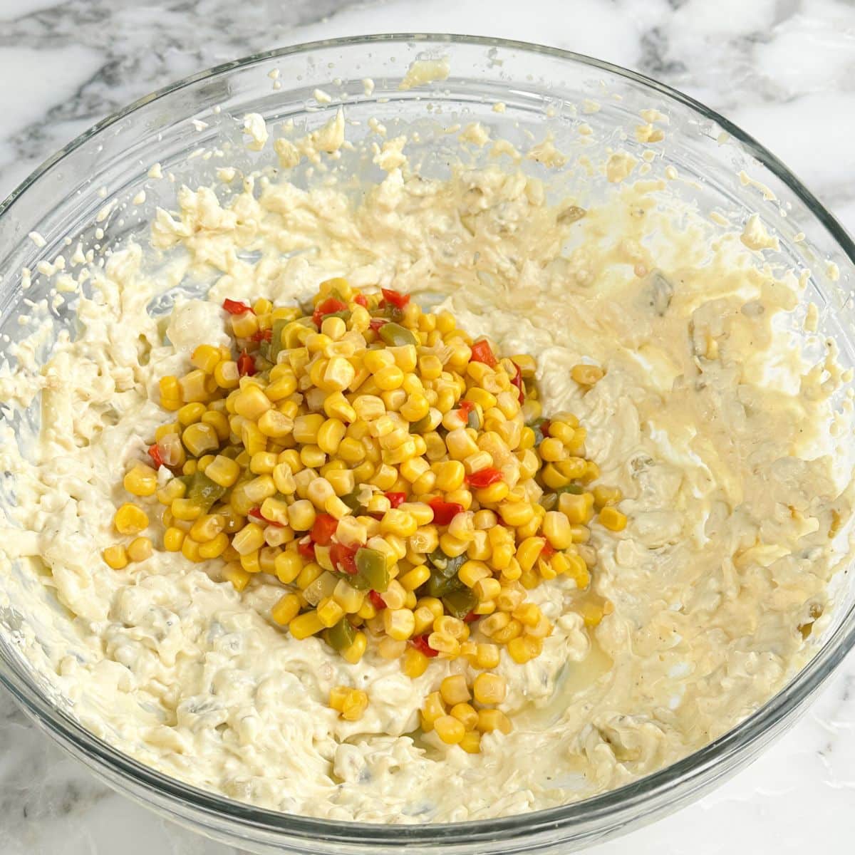 Bowl of cream cheese mixture with fiesta corn.