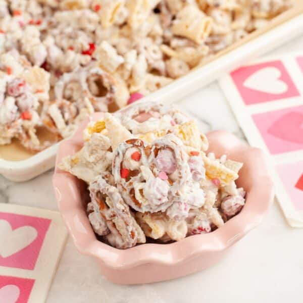 Pink bowl with cupid crunch snack mix.