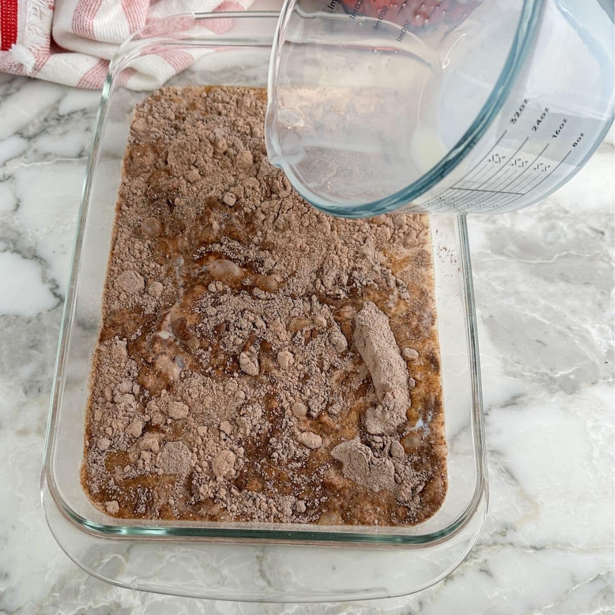 Baking dish with chocolate cake mix and milk.