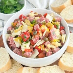 Bowl of muffuletta dip surrounded by toast.