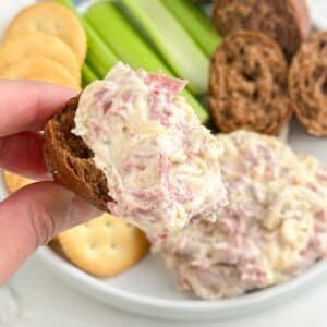 Piece of bread with reuben dip.