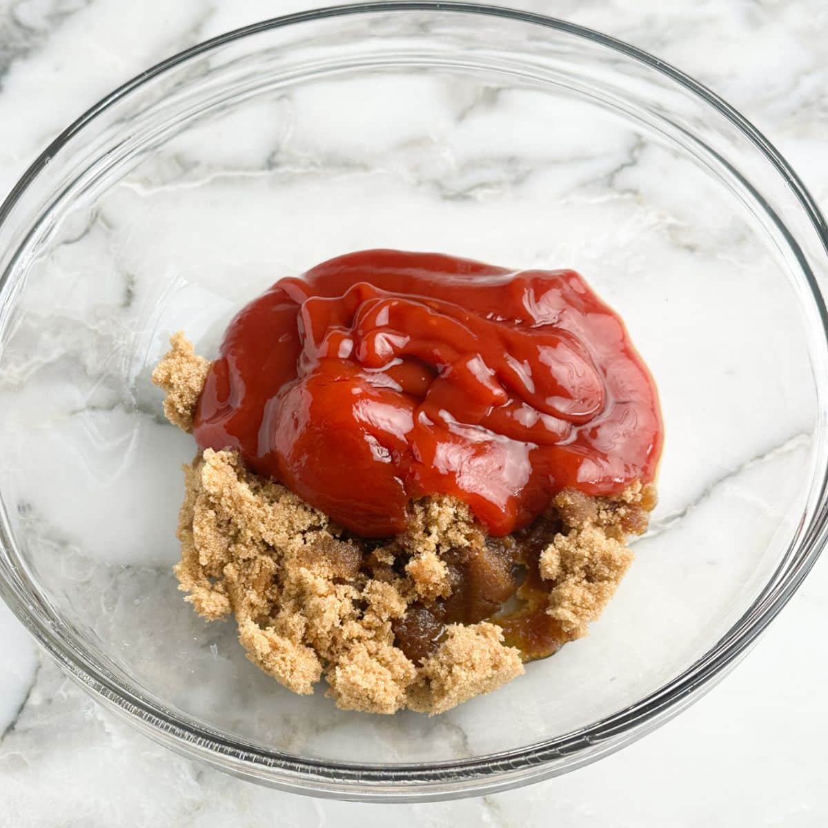Bowl with brown sugar and ketchup. 