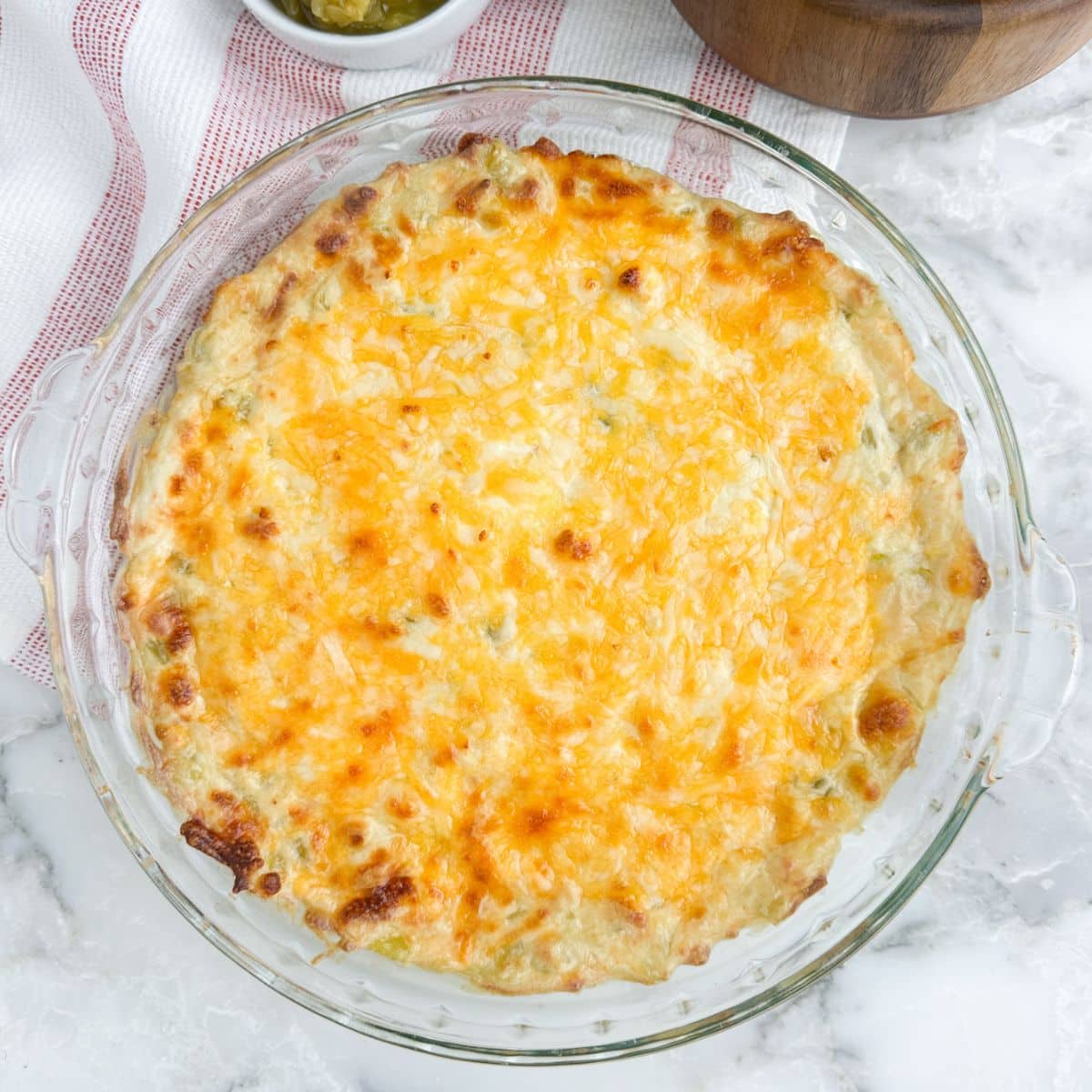 Pie dish with baked green chili dip.
