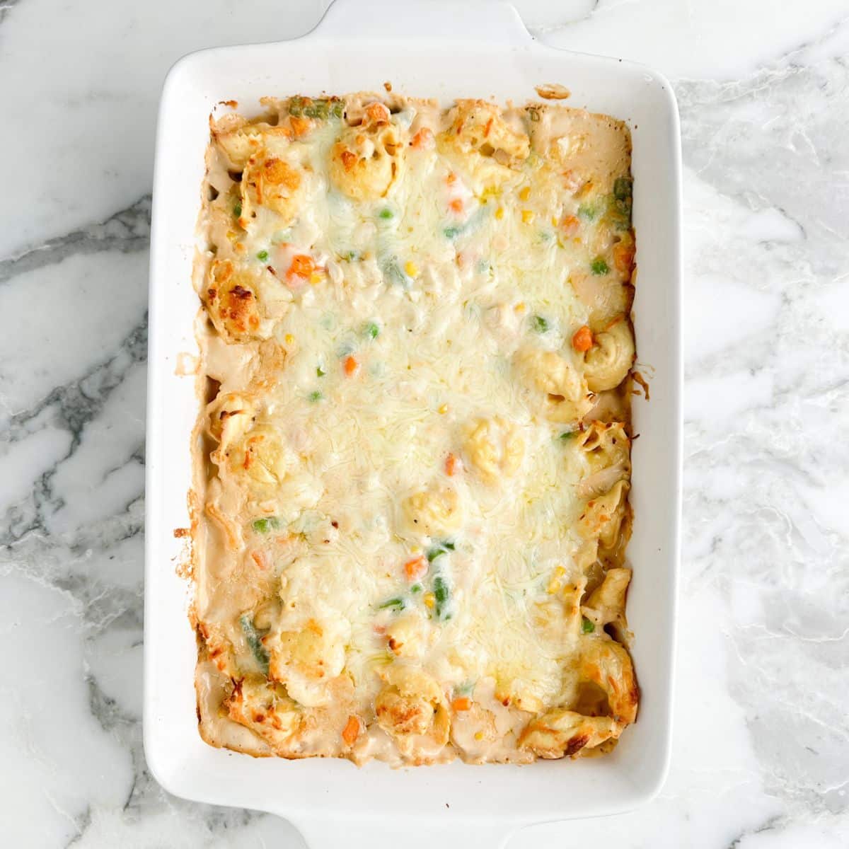 Casserole dish with chicken tortellini casserole. 