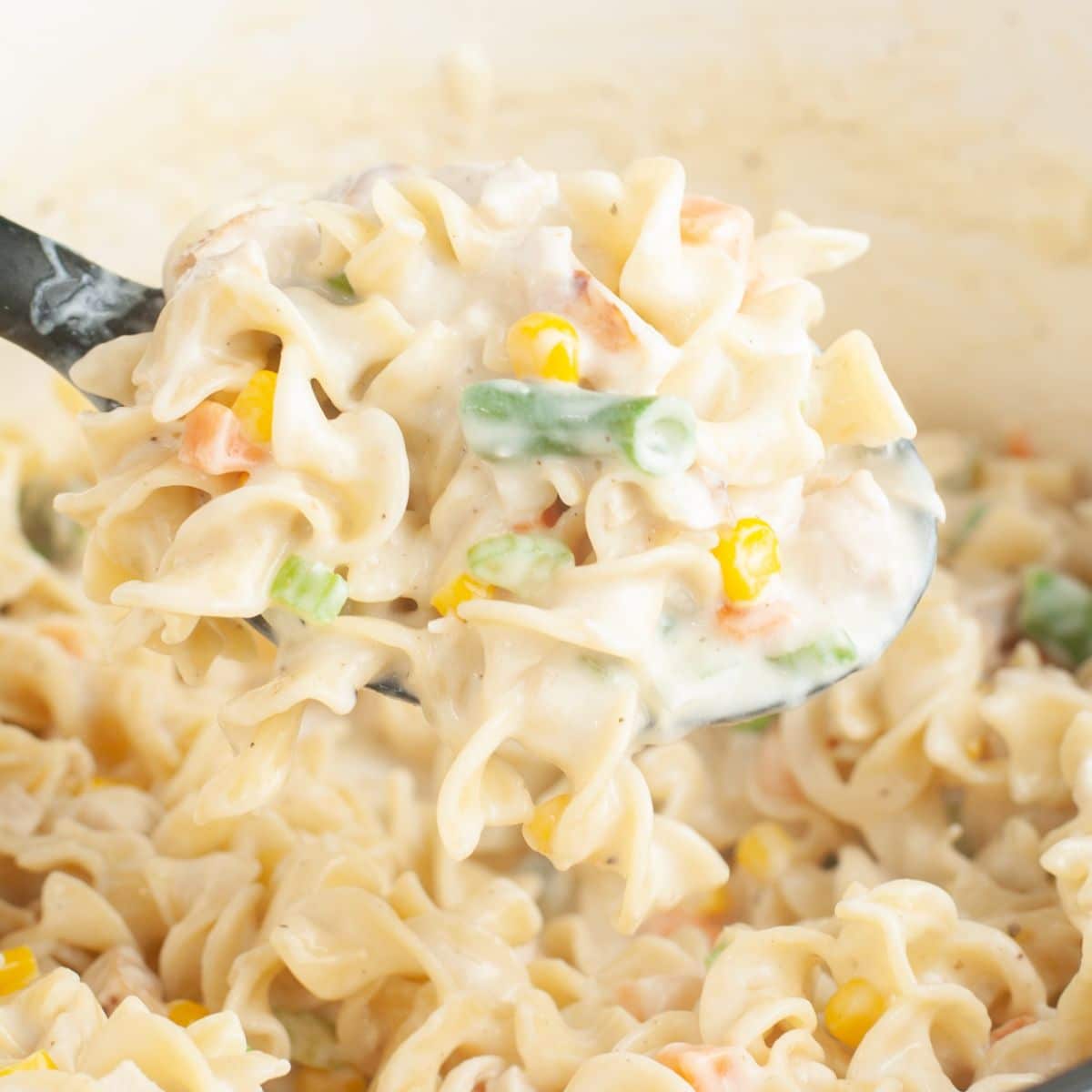 Spoon with chicken pot pie pasta.