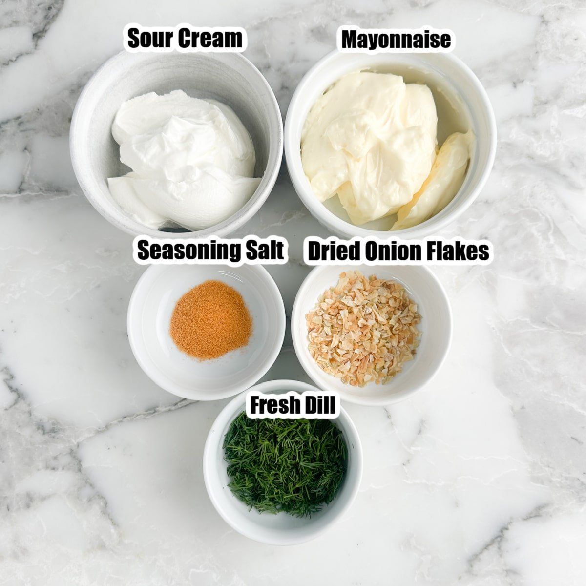 Bowls of sour cream, mayonnaise, seasoned salt, onion flakes, and dill. 