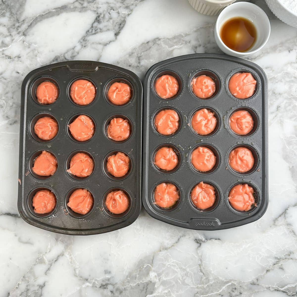 Mini cupcake pan with strawberry cake batter. 