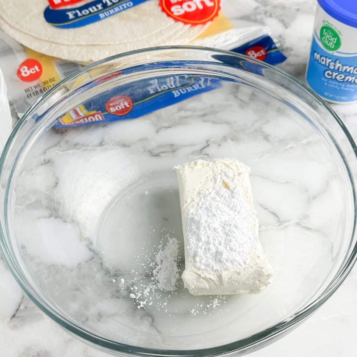 Bowl of cream cheese and powdered sugar. 