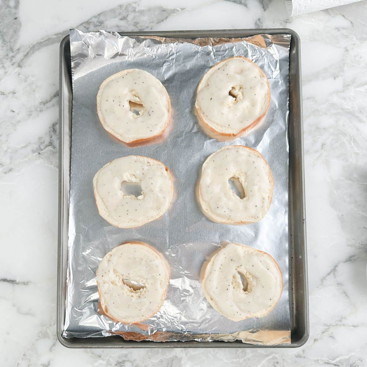 Bagels on a pan topped with gravy.