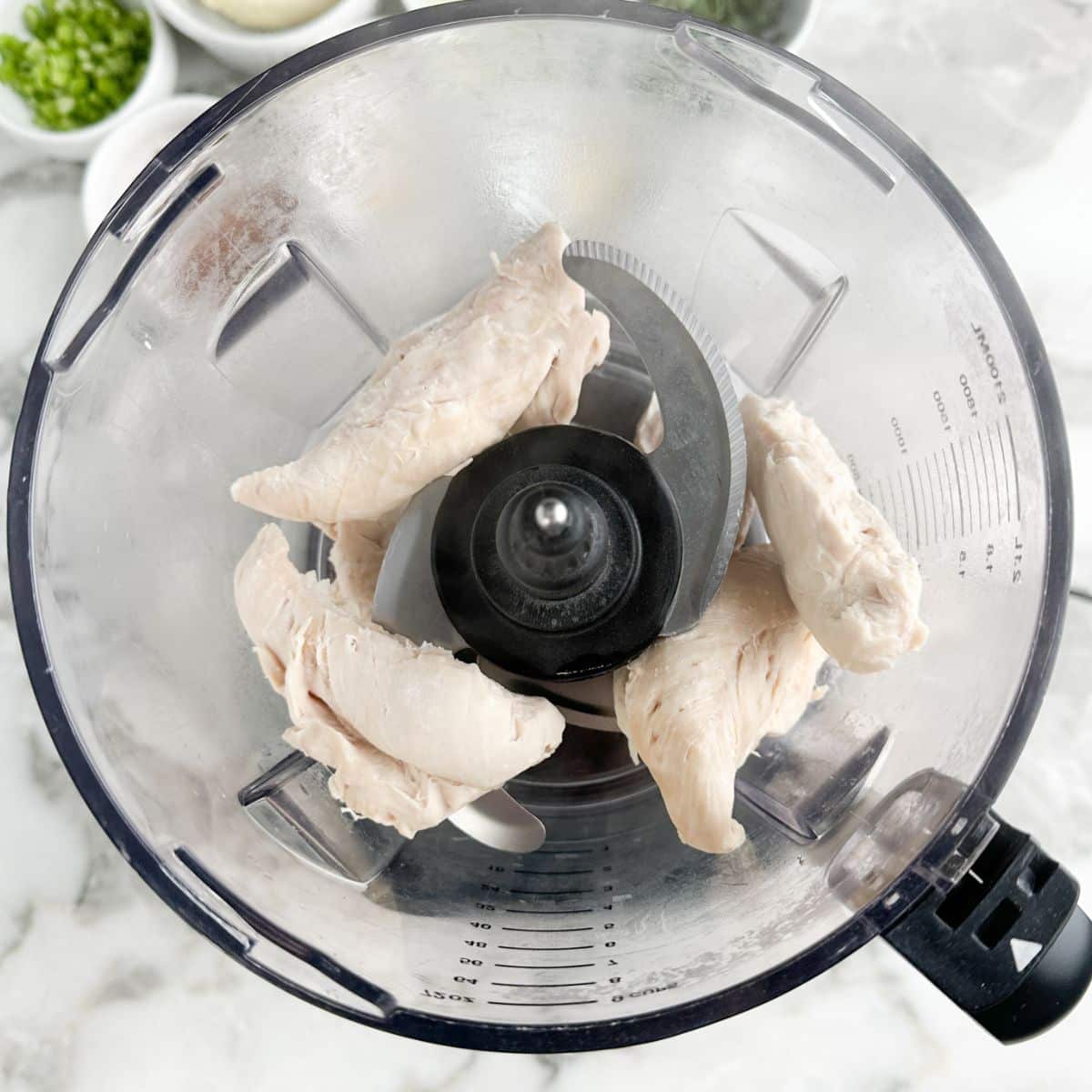 Food processor with chicken tenders.