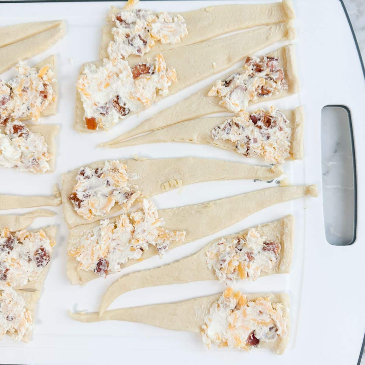 Unbaked crescent rolls topped with cream cheese mixture. 