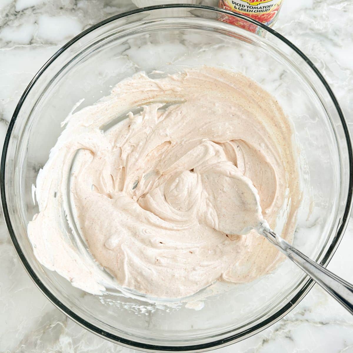 Bowl of sour cream with seasonings. 