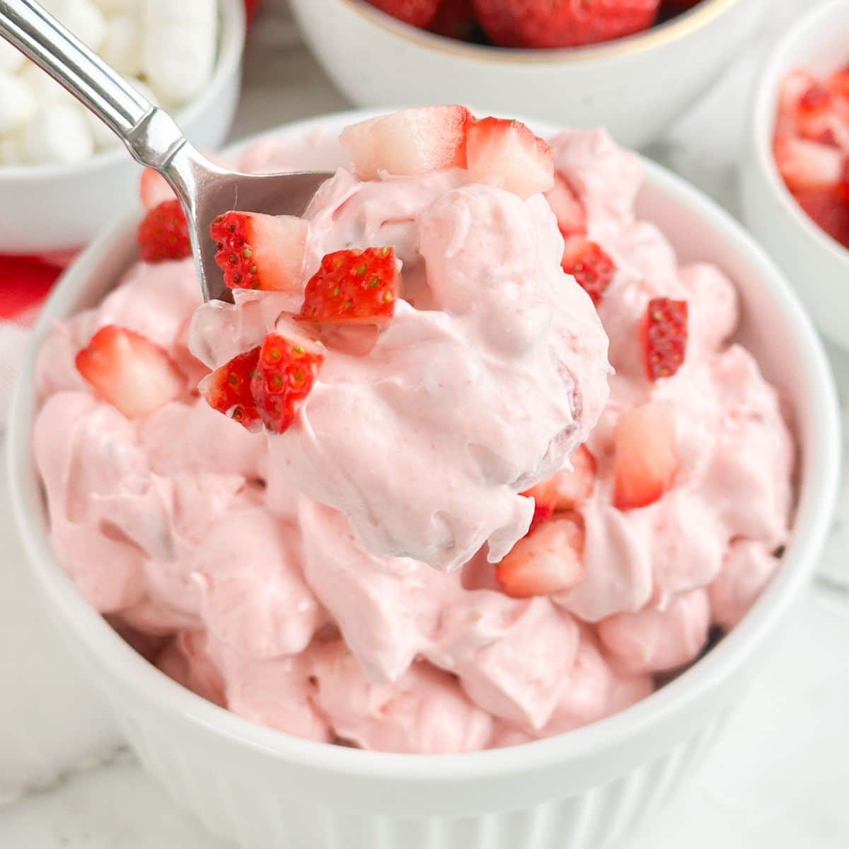 Bowl of strawberry fluff with a spoon.