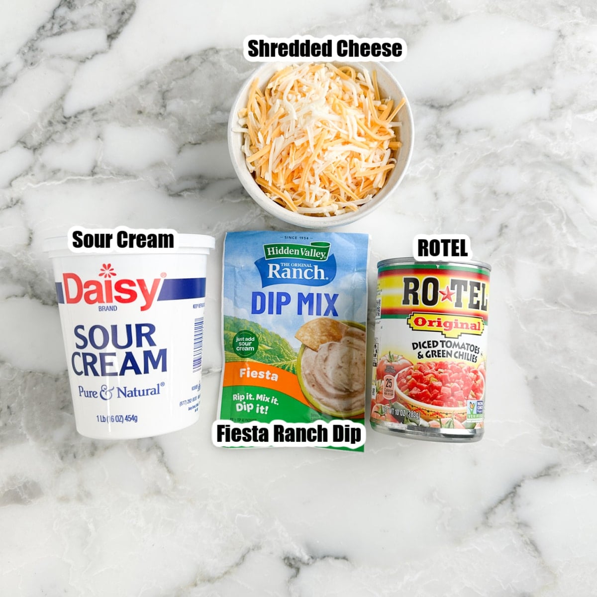 Sour cream, bowl of shredded cheese, fiesta ranch seasoning, and ROTEL.