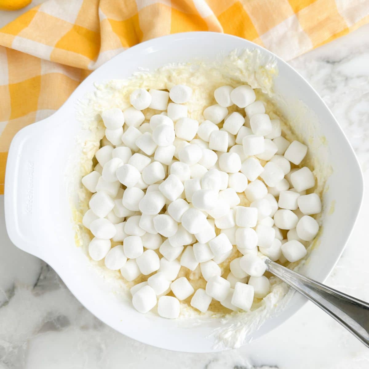 Bowl with mini marshmallows and crushed pineapple. 