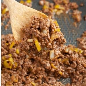 Wooden spoon with mississippi sloppy joe meat.