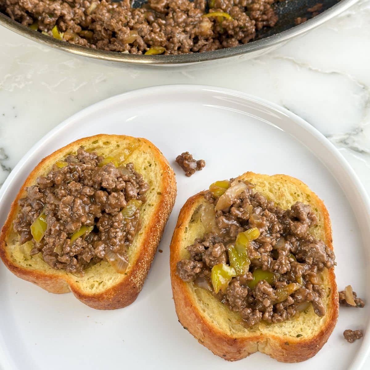 Garlic toast topped with Mississippi sloppy joes meat.