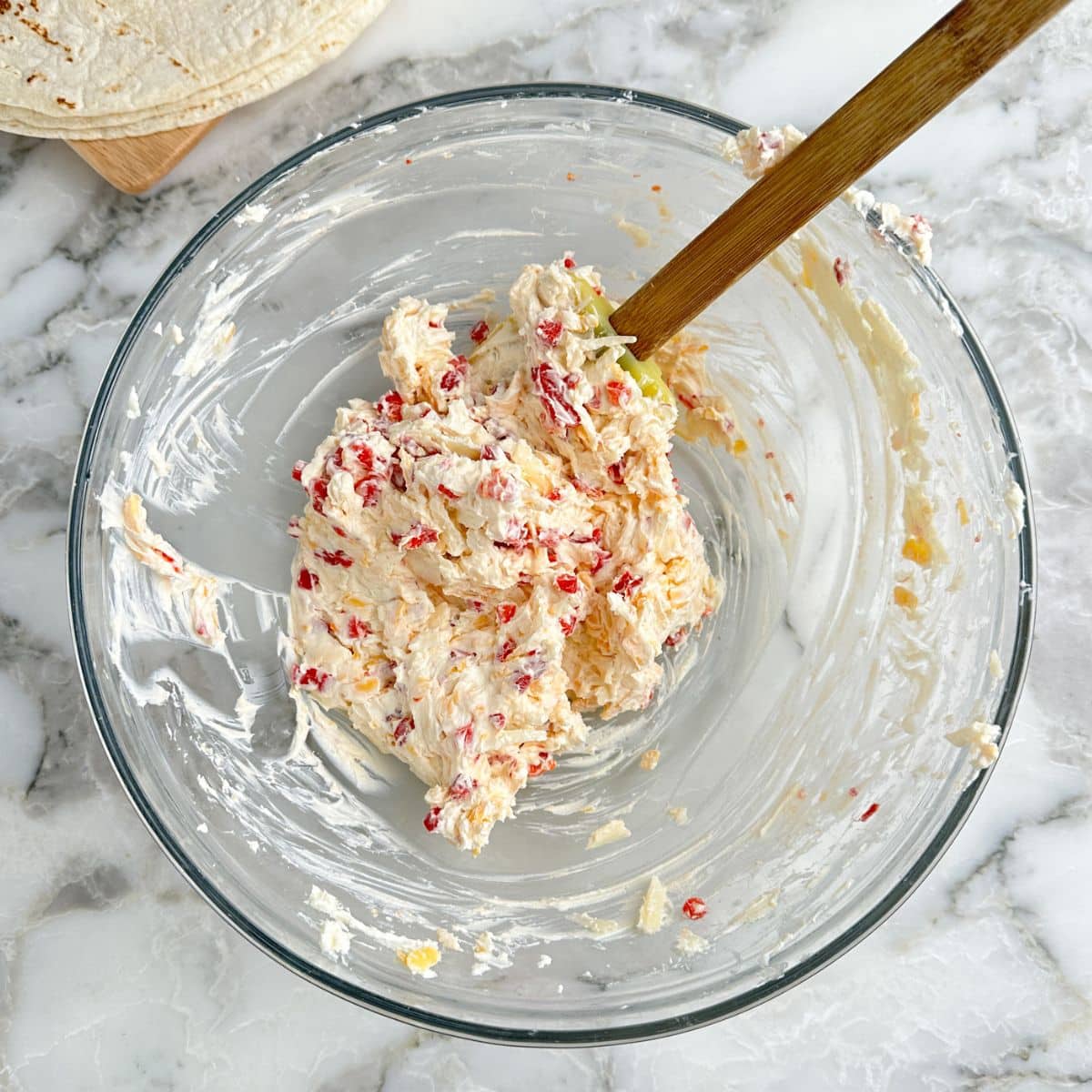 Bowl of pimento cheese with a spatula 