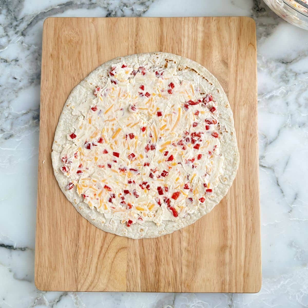 Tortilla topped with pimento cheese. 