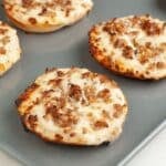 School breakfast pizza bagel with sausage and cheese.