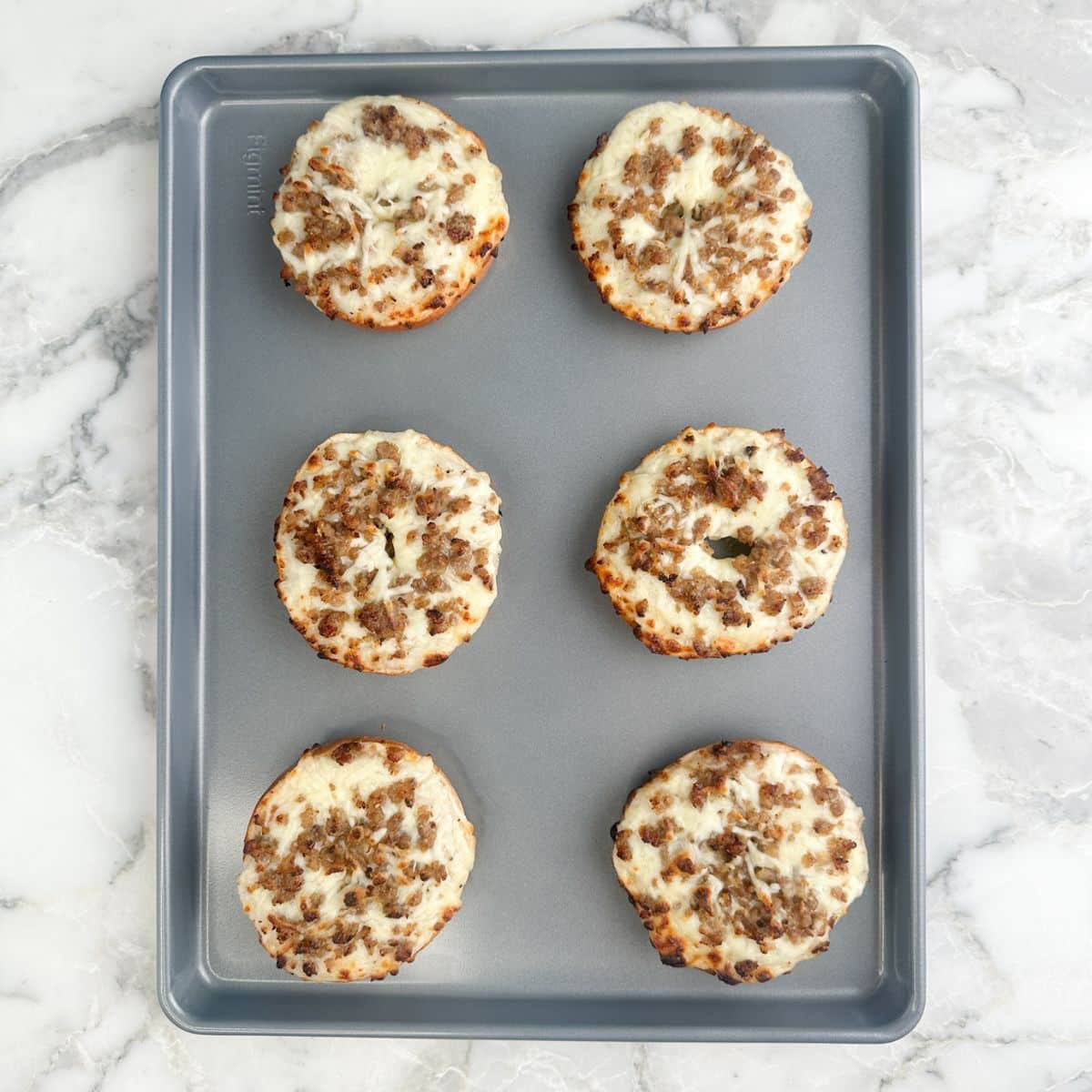 Baking pan with breakfast bagels. 