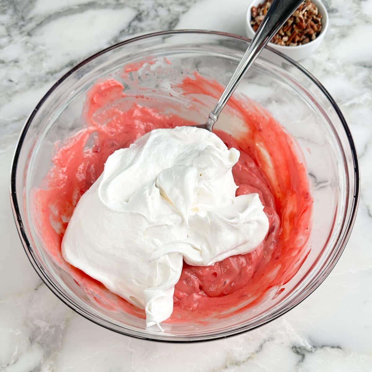Bowl with strawberry pie filling and whipped topping.