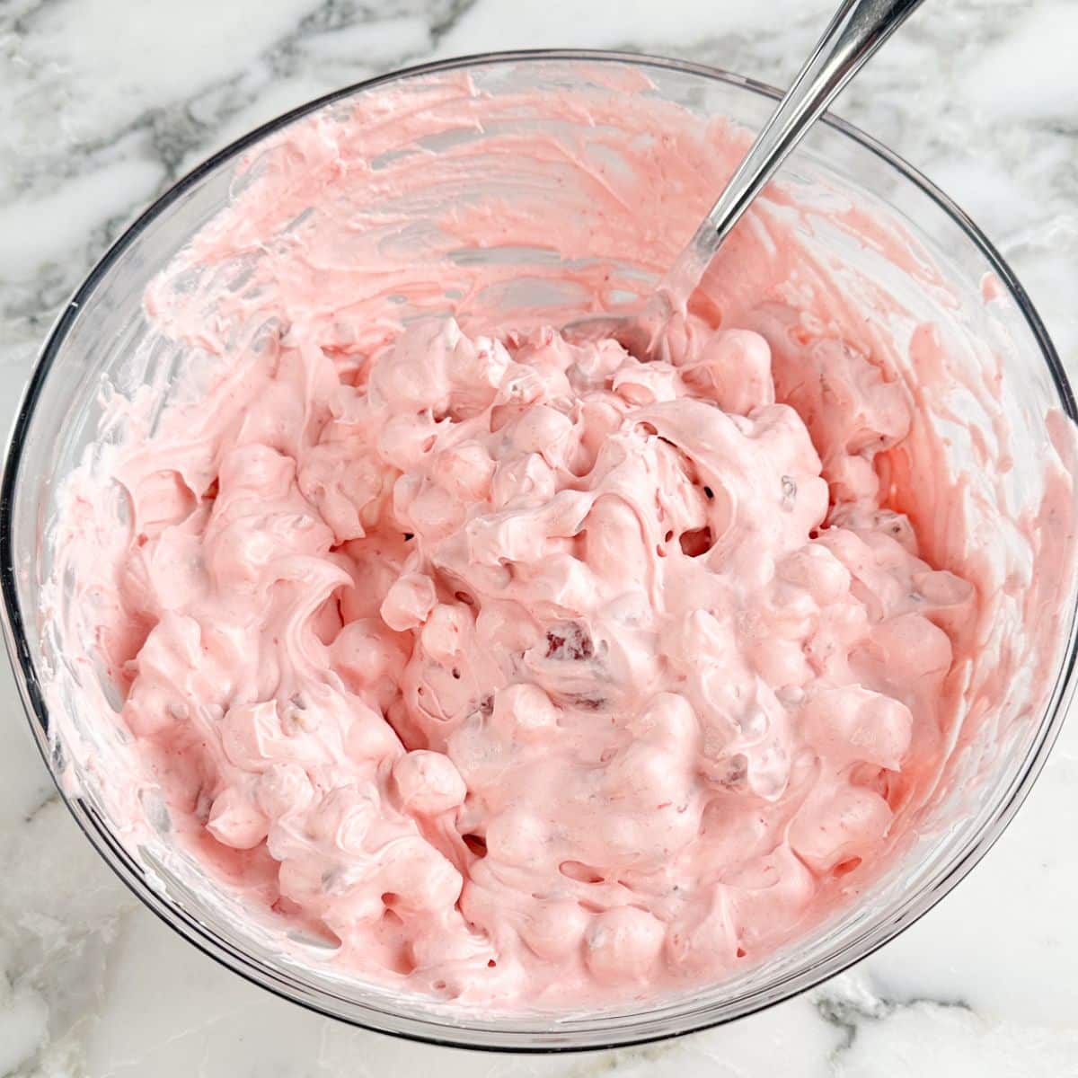 Bowl of strawberry fluff with mini marshmallows.