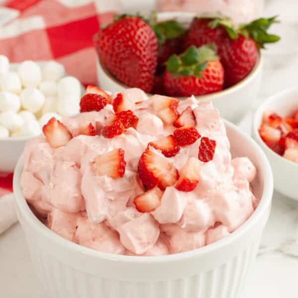 Bowl with strawberry fluff topped with diced strawberries.