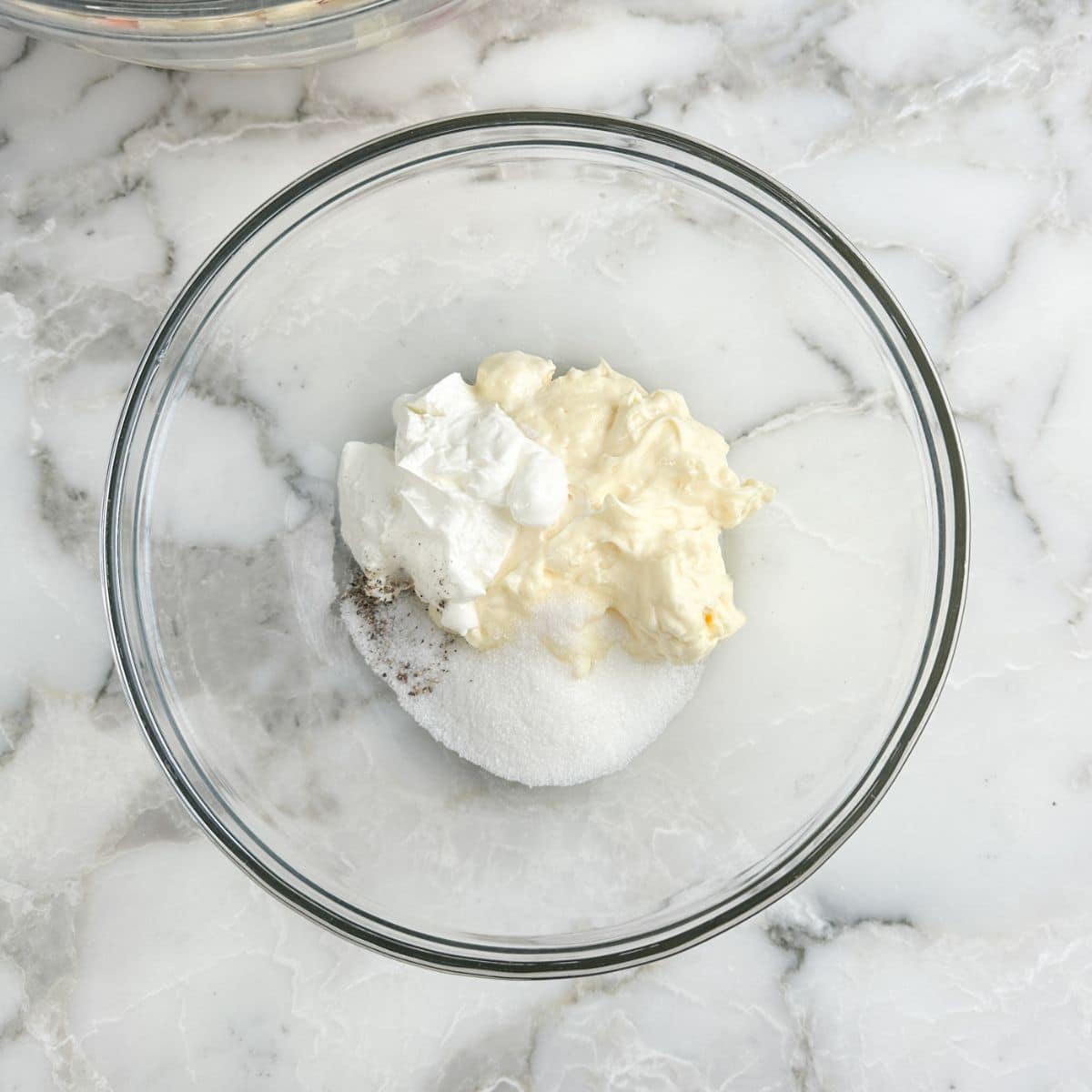 Bowl of mayonnaise, sour cream, and sugar. 