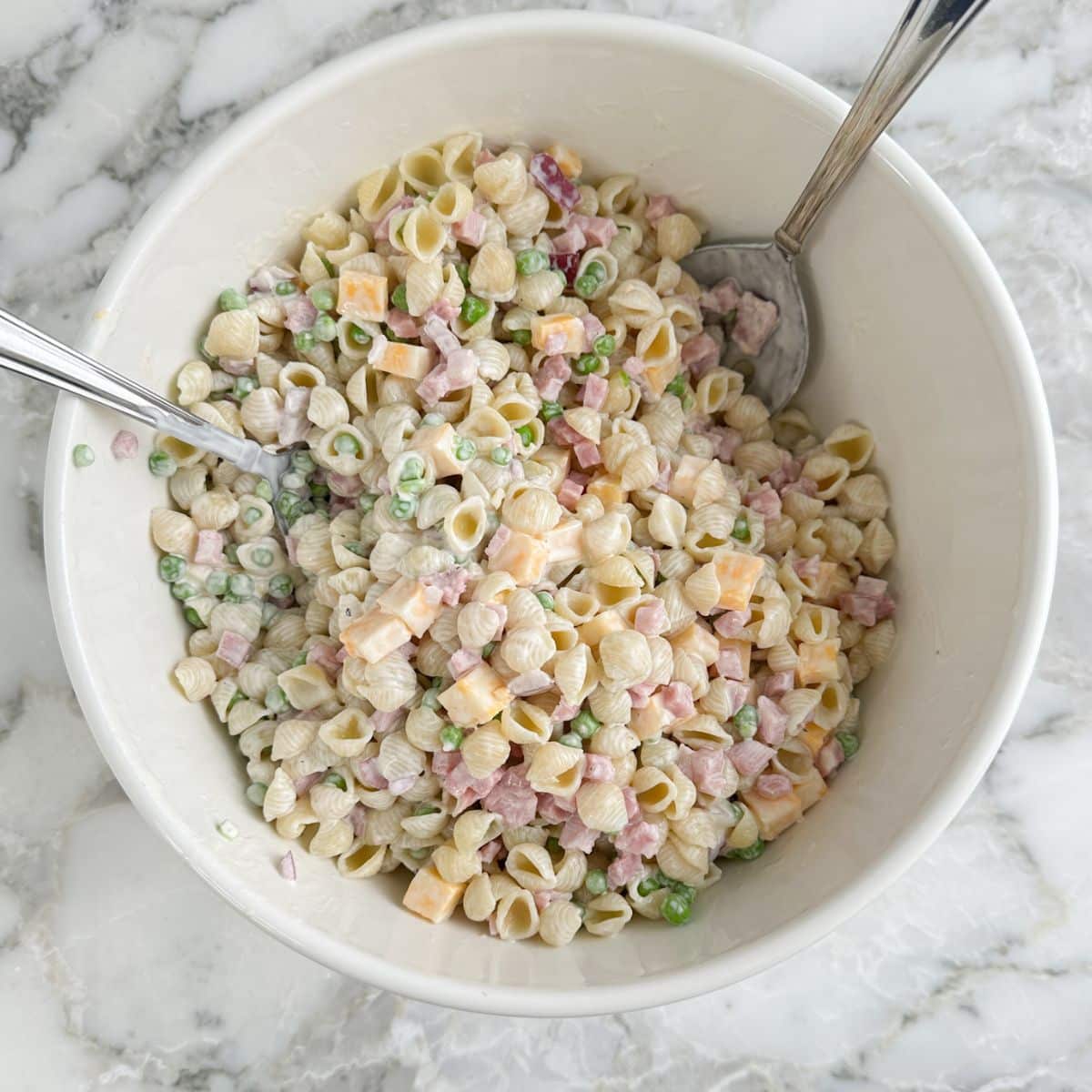 Bowl of pasta salad with spoons. 