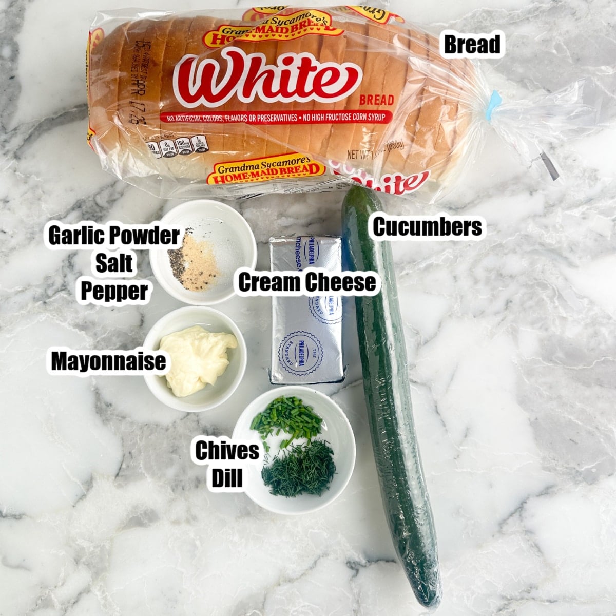 Bread, cucumber, mayonnaise, cream cheese, seasonings, dill, and chives.
