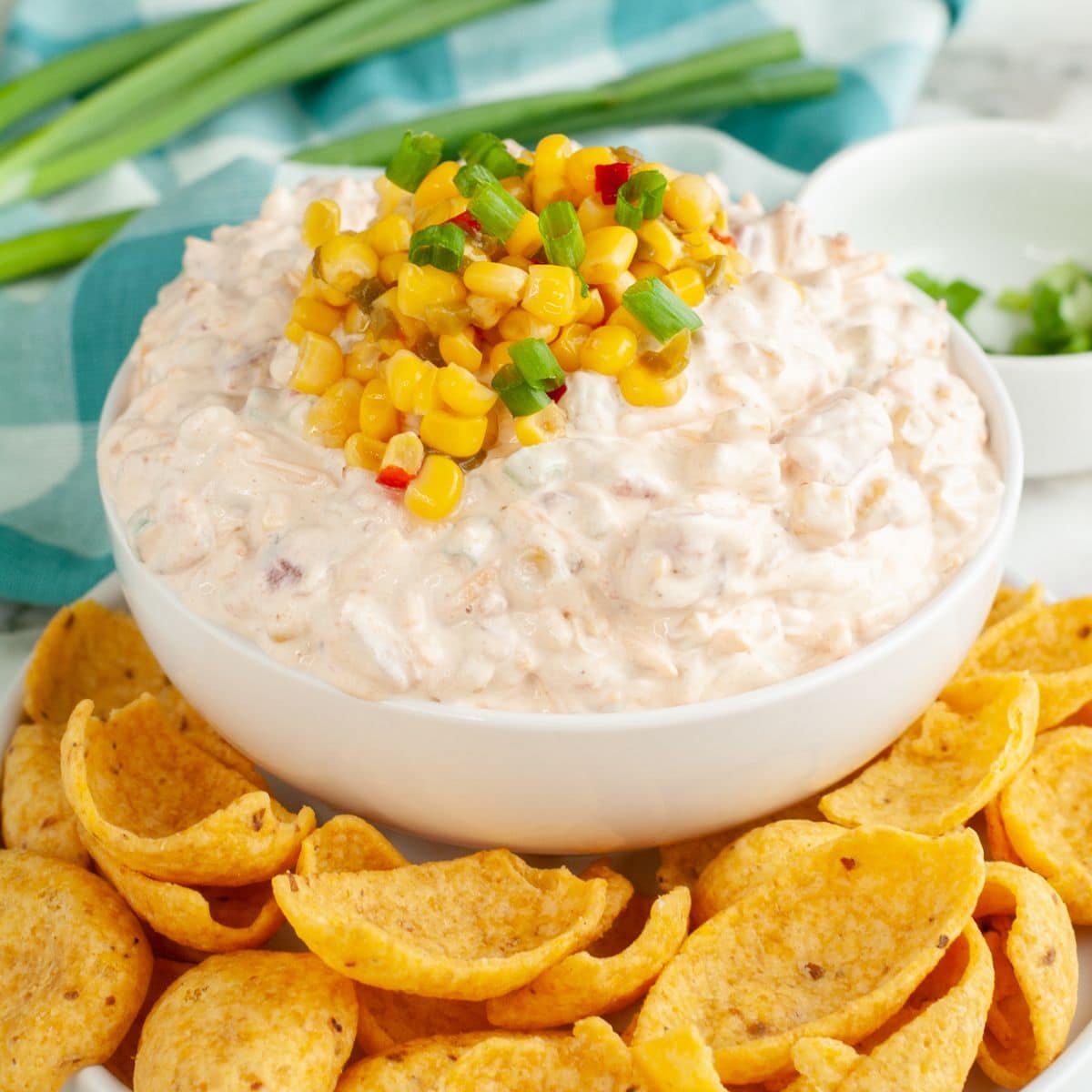 Bowl of fiesta corn dip topped with corn kernels. 