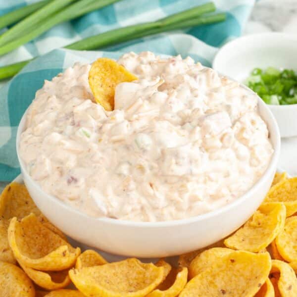 Bowl of fiesta corn dip with corn chips.