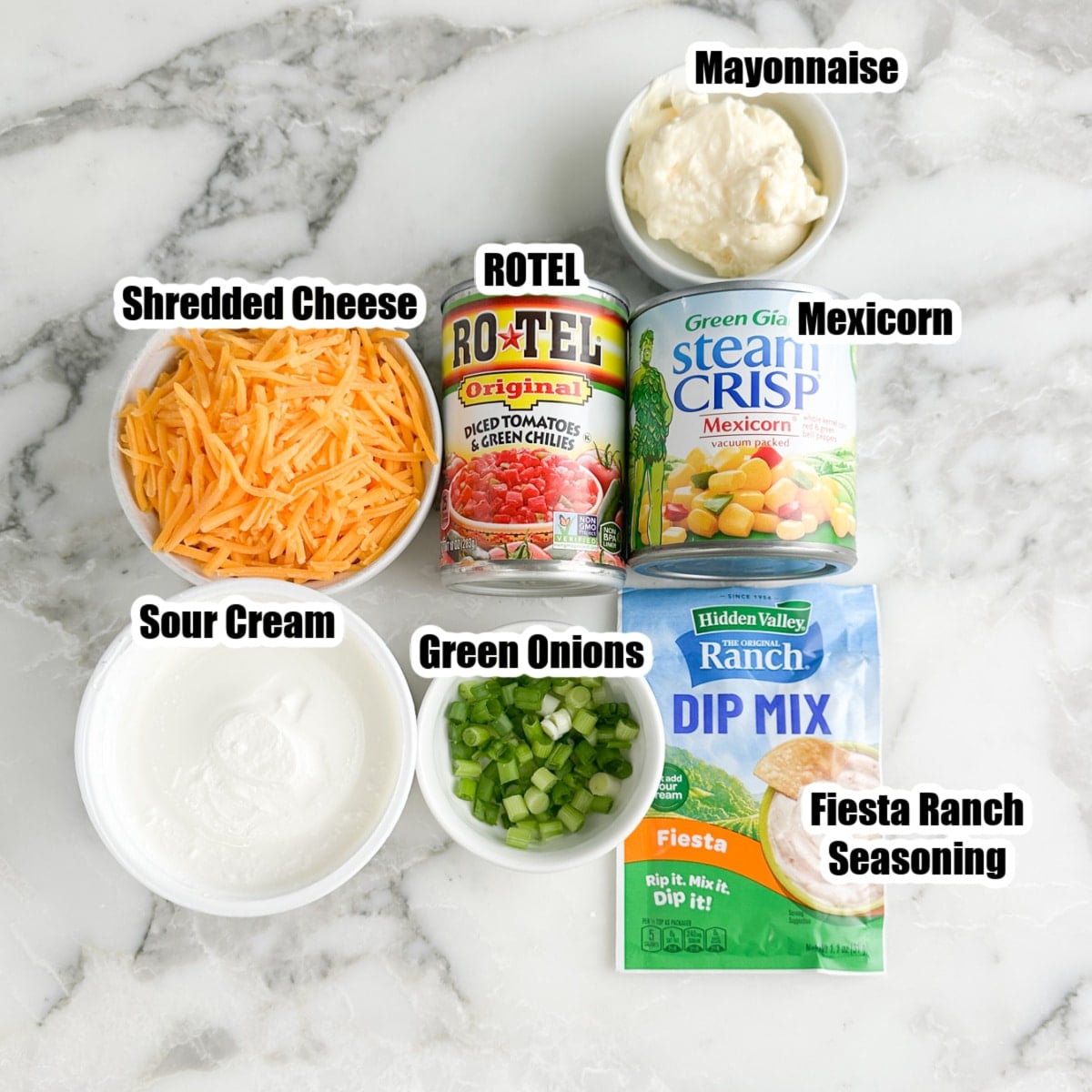 Bowl of shredded cheese, sour cream, diced green onions, ROTEL, mexicorn, mayonnaise, and fiesta ranch seasonings. 