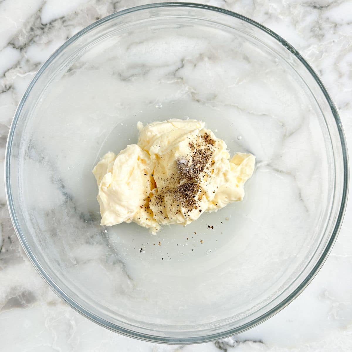 Bowl of mayonnaise with seasonings. 