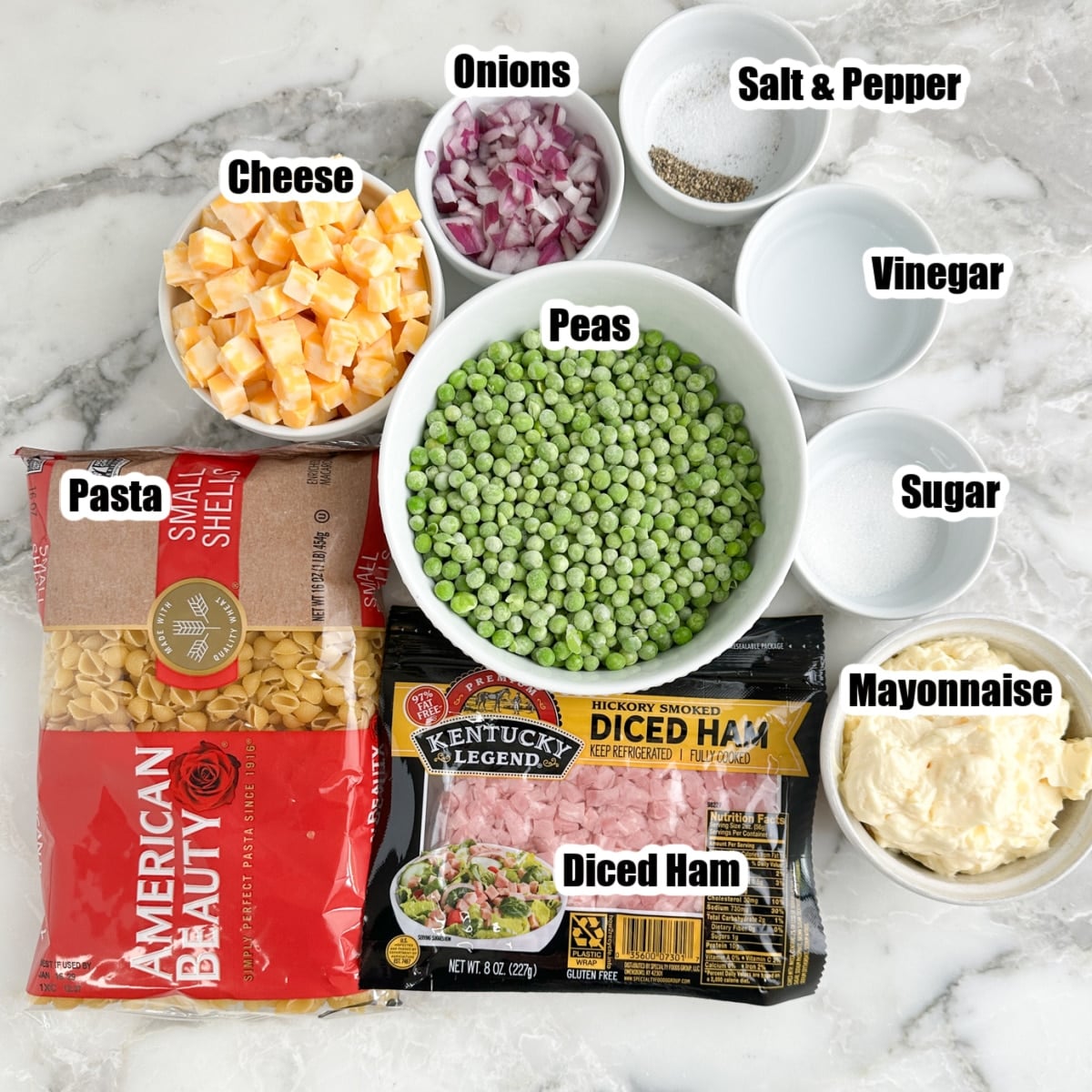 Bag of pasta, peas, cubed cheese, diced ham, onions, mayonnaise, sugar, vinegar, salt, pepper. 